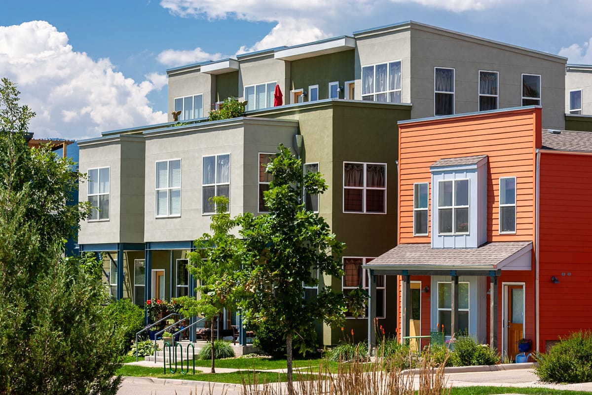Modern colorful townhomes under a blue sky